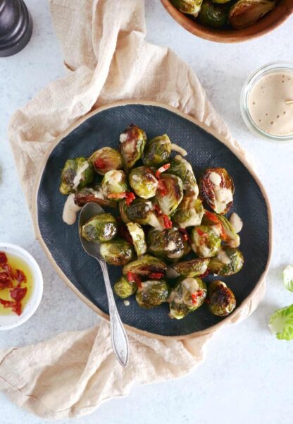 Soy roasted Brussels sprouts with cashew sauce are crispy, tender, with a subtle Asian touch.