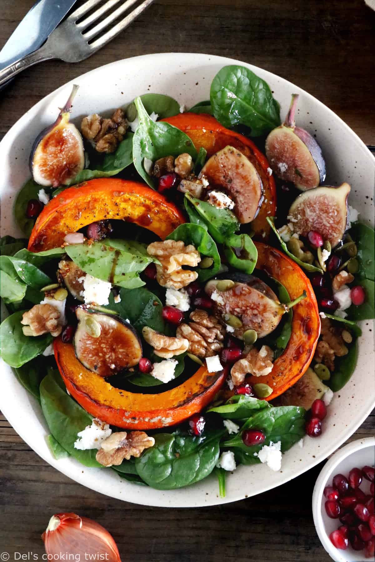 This roasted squash salad features caramelized figs with balsamic vinegar, baby spinach, and a subtle shallot vinaigrette.