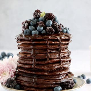 Perfect chocolate pancakes are easy to make, fluffy, and topped with a rich hot chocolate sauce.