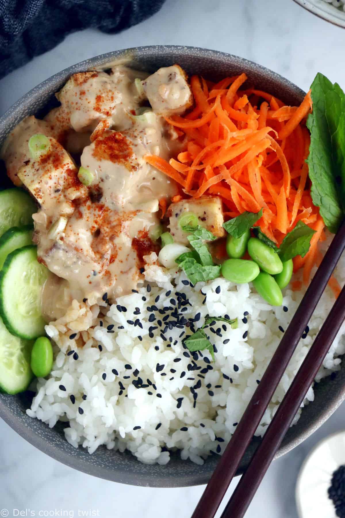 This easy spicy peanut tofu power bowl is vegan, gluten-free, high in plant-based protein and packed with good-for-you ingredients.