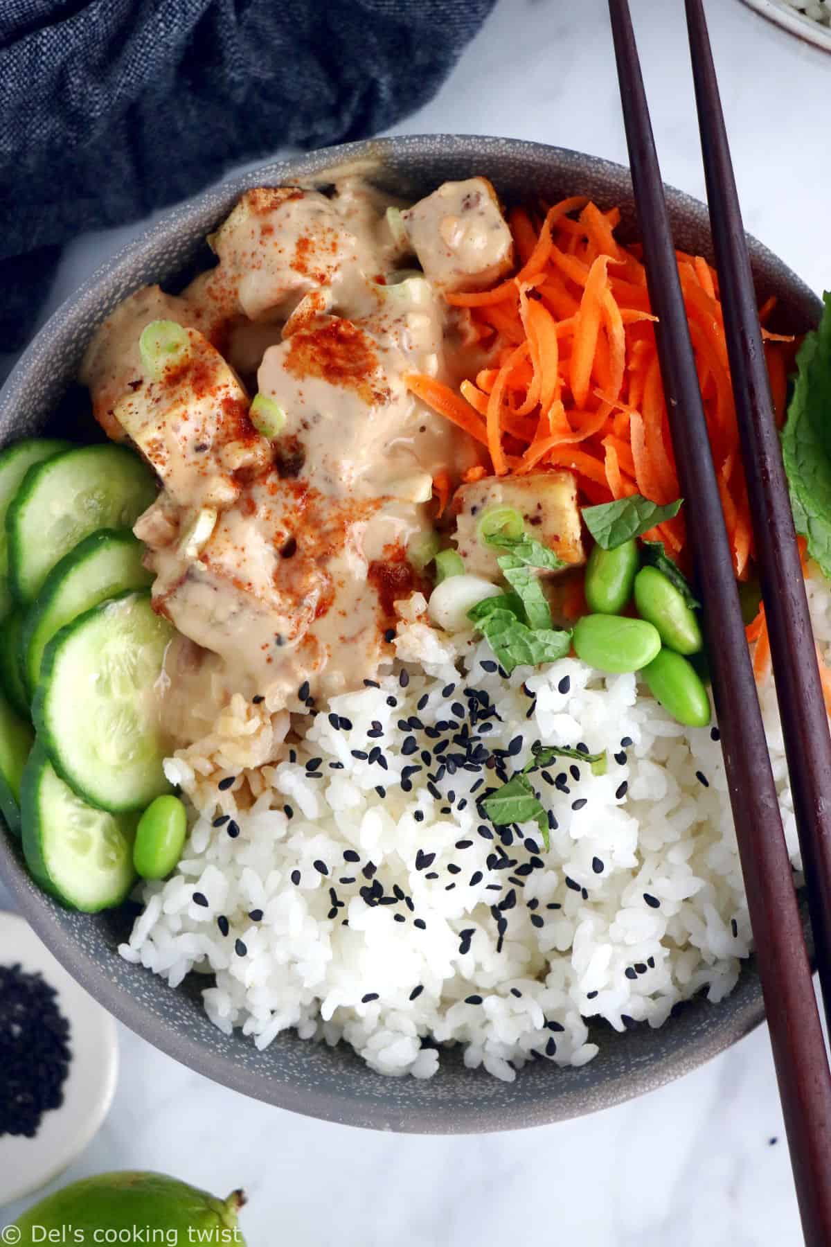 This easy spicy peanut tofu power bowl is vegan, gluten-free, high in plant-based protein and packed with good-for-you ingredients.