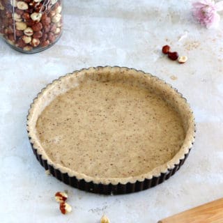 Hazelnut pie crust is a sweet shortcrust pastry prepared with ground hazelnuts. The dough comes together easily with just a few ingredients and has a subtle nutty flavor.