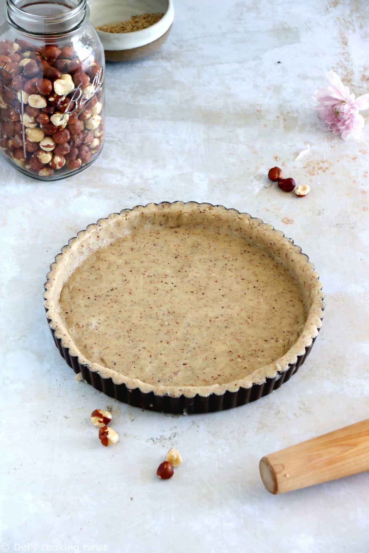 Hazelnut pie crust is a sweet shortcrust pastry prepared with ground hazelnuts. The dough comes together easily with just a few ingredients and has a subtle nutty flavor.