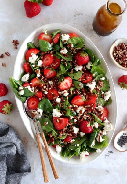 This strawberry spinach salad with goat cheese is tossed in a flavorful balsamic poppy seed dressing. A simple summer salad recipe!