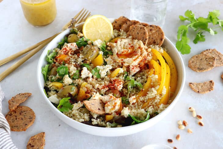 This Mediterranean quinoa salad recipe is as easy as it gets. Both vegetarian and gluten-free, this colorful salad is loaded with veggies.