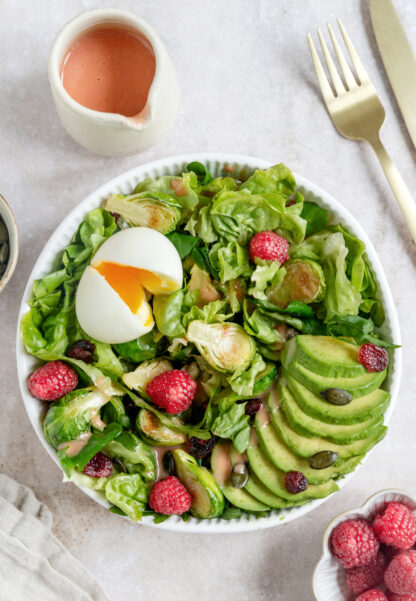 This vibrant avocado raspberry salad with soft-boiled eggs comes with a sweet and subtle raspberry vinaigrette.