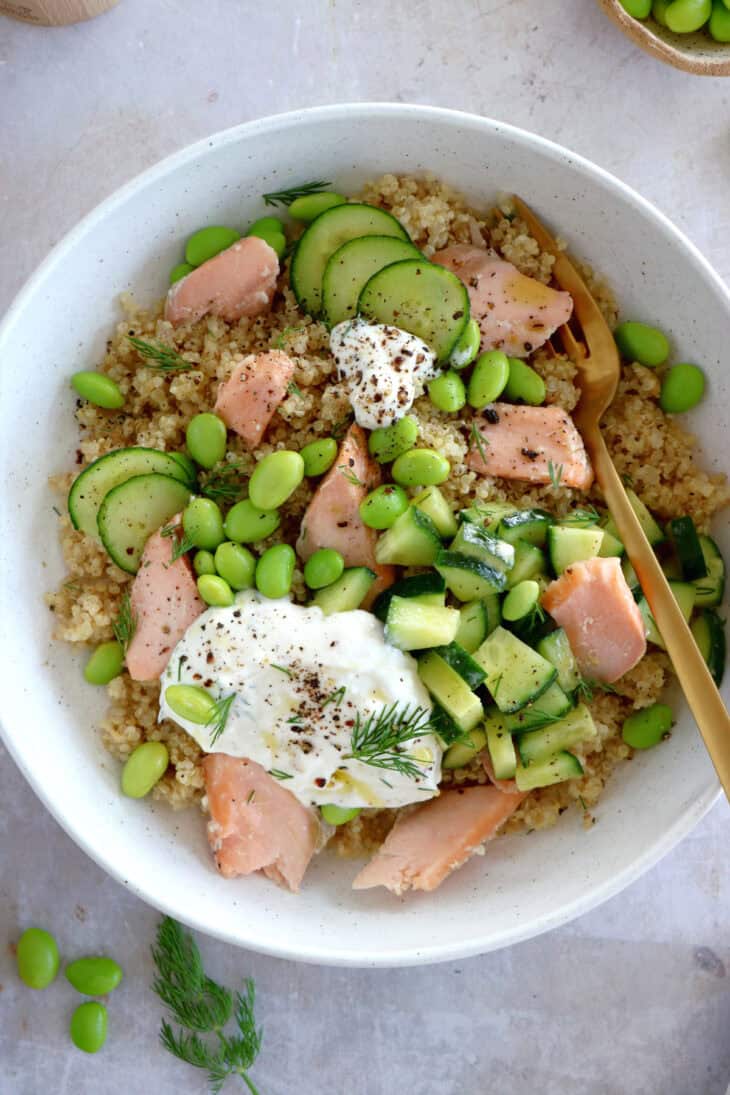 This delicious salmon quinoa bowl with edamame and a dill-feta dip makes a great lunch recipe. Healthy and nutritious!