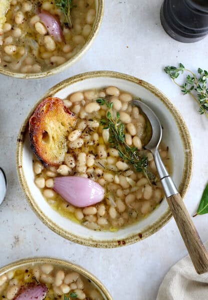 These brothy white beans infused with fresh herbs make a cozy meal packed with flavors. They're easy to make (no soaking time needed).