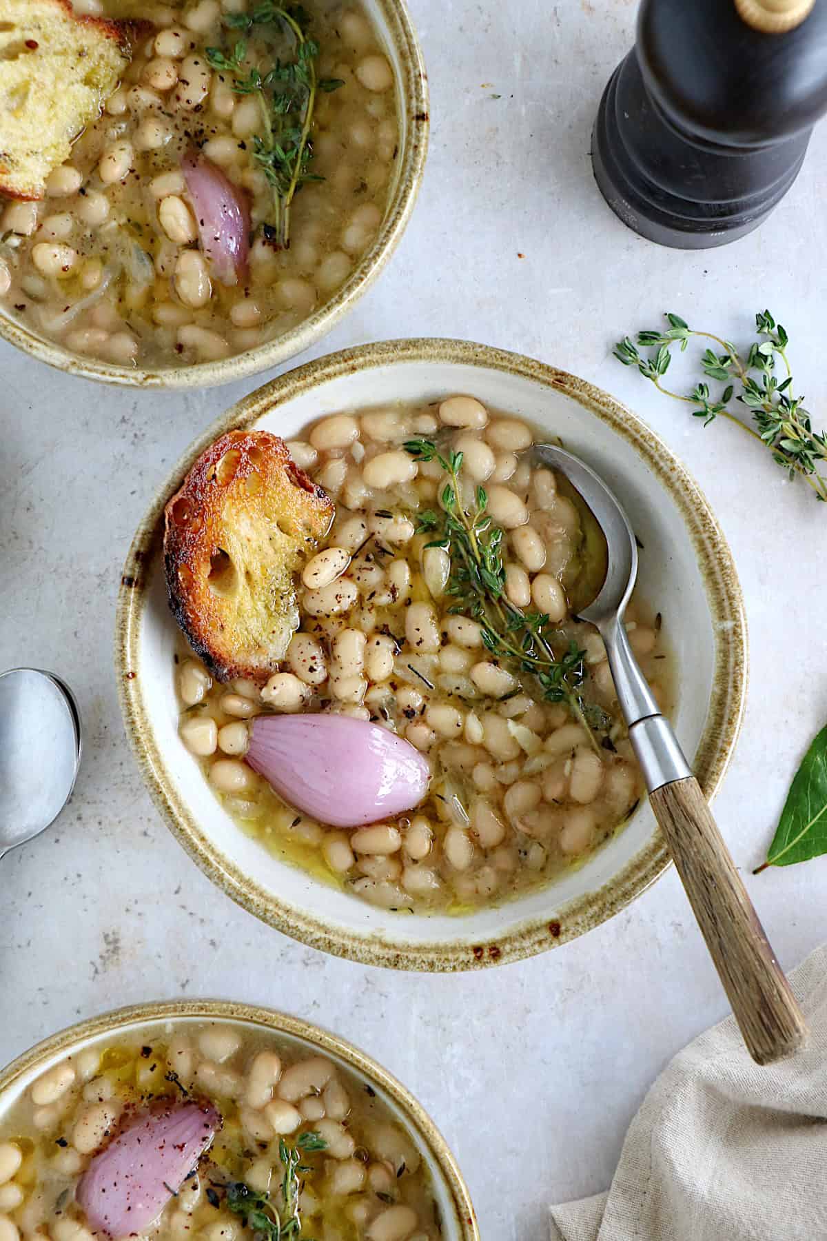 These brothy white beans infused with fresh herbs make a cozy meal packed with flavors. They're easy to make (no soaking time needed).