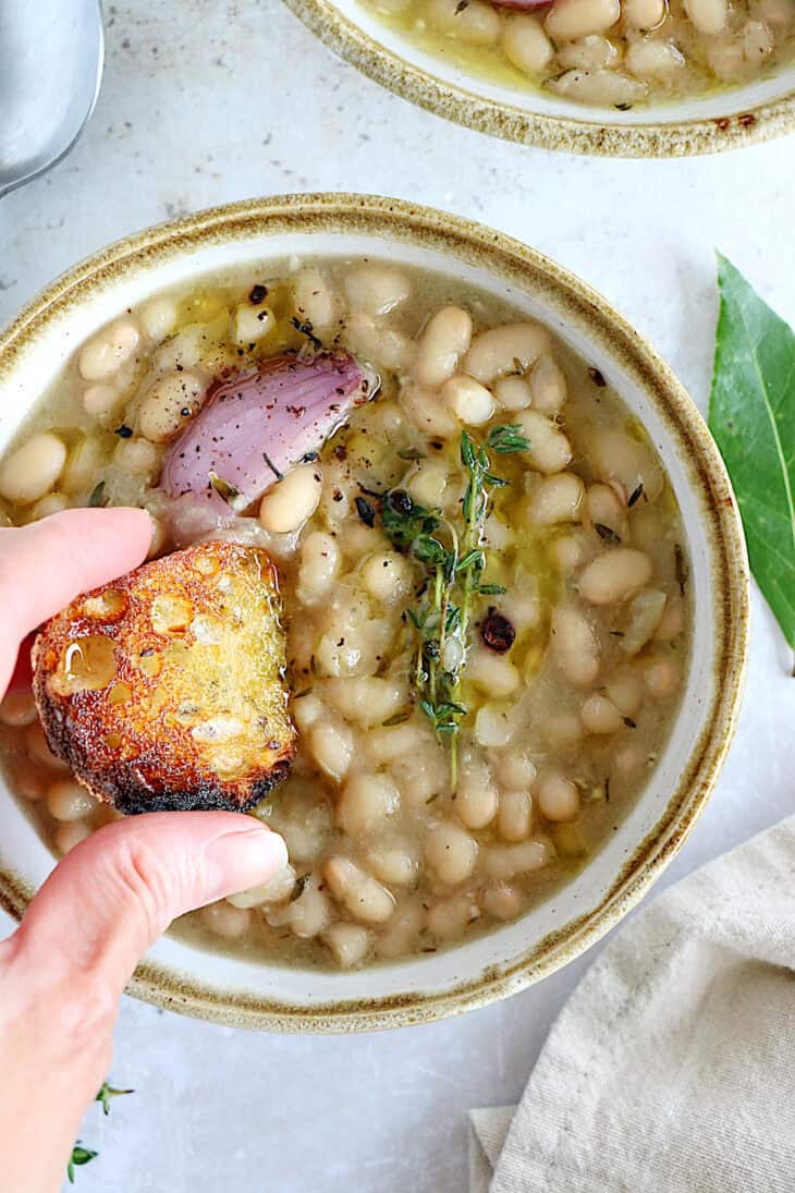 These brothy white beans infused with fresh herbs make a cozy meal packed with flavors. They're easy to make (no soaking time needed).