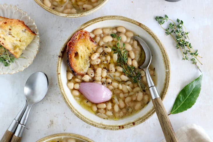 These brothy white beans infused with fresh herbs make a cozy meal packed with flavors. They're easy to make (no soaking time needed).