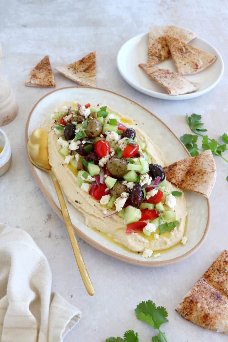 This loaded hummus dip is an easy crowd-pleasing appetizer, with lots of textures and refreshing flavors.