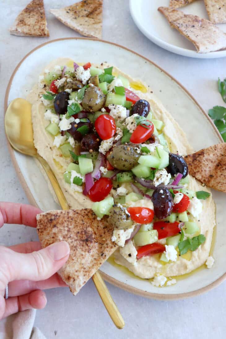 This loaded hummus dip is an easy crowd-pleasing appetizer, with lots of textures and refreshing flavors.