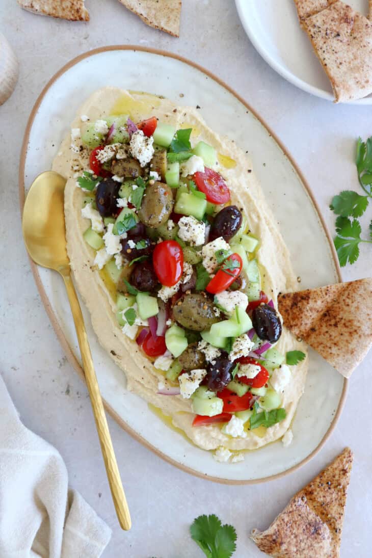 This loaded hummus dip is an easy crowd-pleasing appetizer, with lots of textures and refreshing flavors.