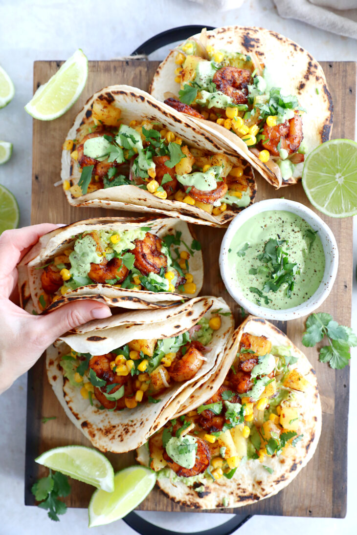 These sheet pan pineapple shrimp tacos with a spicy jalapeño sauce make an easy 20-minute dinner, that tastes better than takeout.