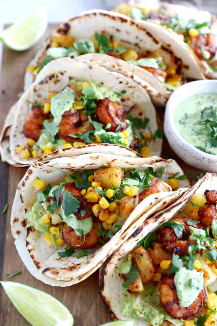 These sheet pan pineapple shrimp tacos with a spicy jalapeño sauce make an easy 20-minute dinner, that tastes better than takeout.
