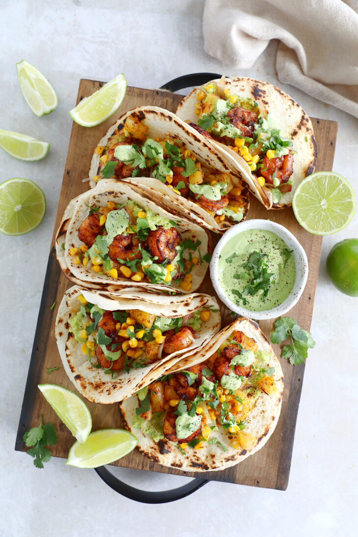 These sheet pan pineapple shrimp tacos with a spicy jalapeño sauce make an easy 20-minute dinner, that tastes better than takeout.