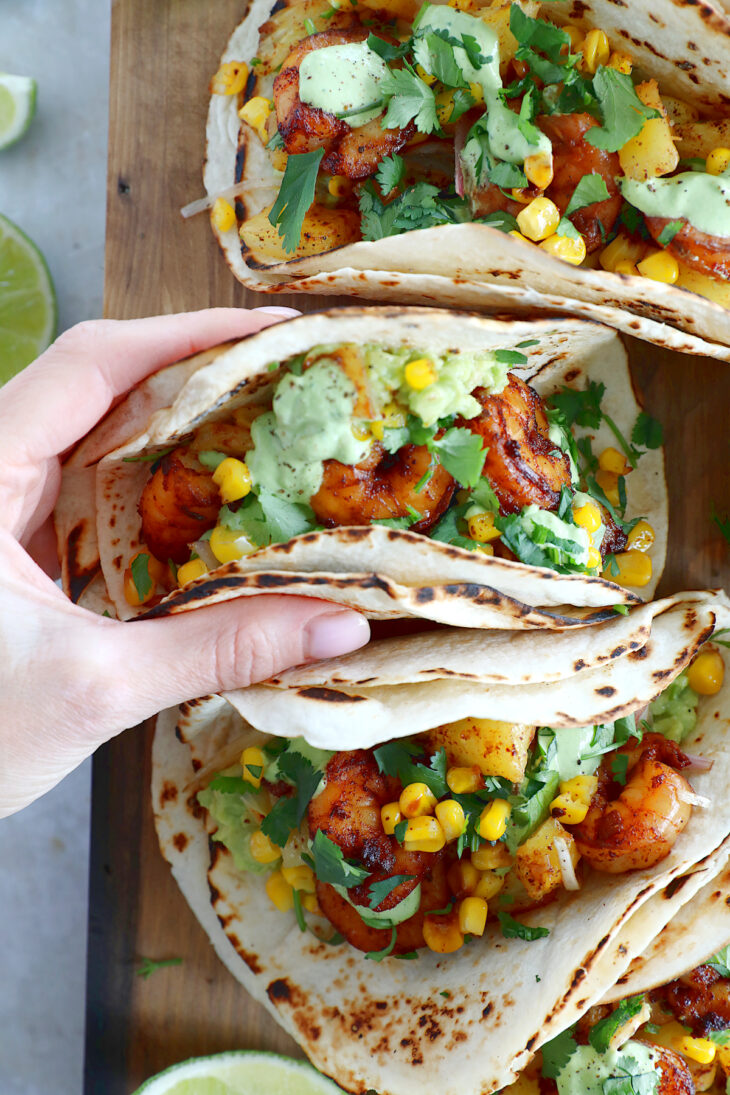 These sheet pan pineapple shrimp tacos with a spicy jalapeño sauce make an easy 20-minute dinner, that tastes better than takeout.