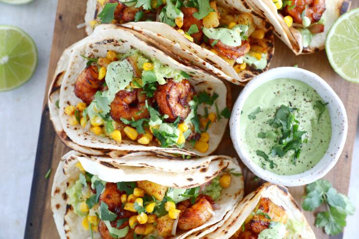 These sheet pan pineapple shrimp tacos with a spicy jalapeño sauce make an easy 20-minute dinner, that tastes better than takeout.