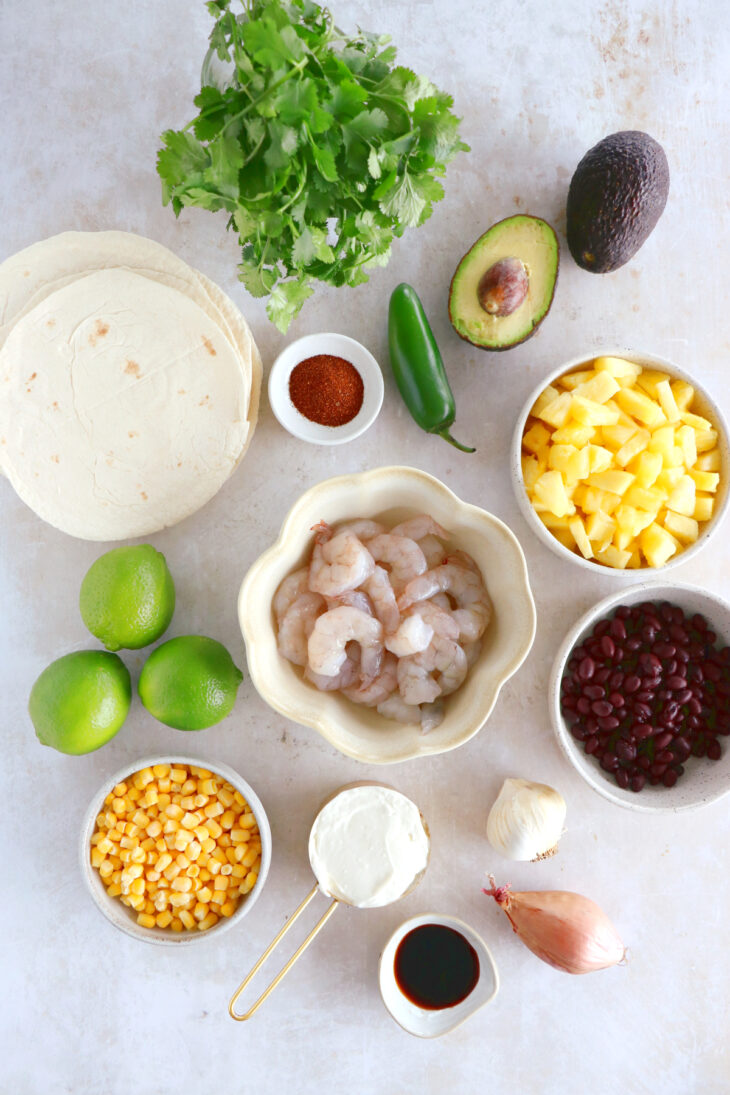 These sheet pan pineapple shrimp tacos with a spicy jalapeño sauce make an easy 20-minute dinner, that tastes better than takeout.
