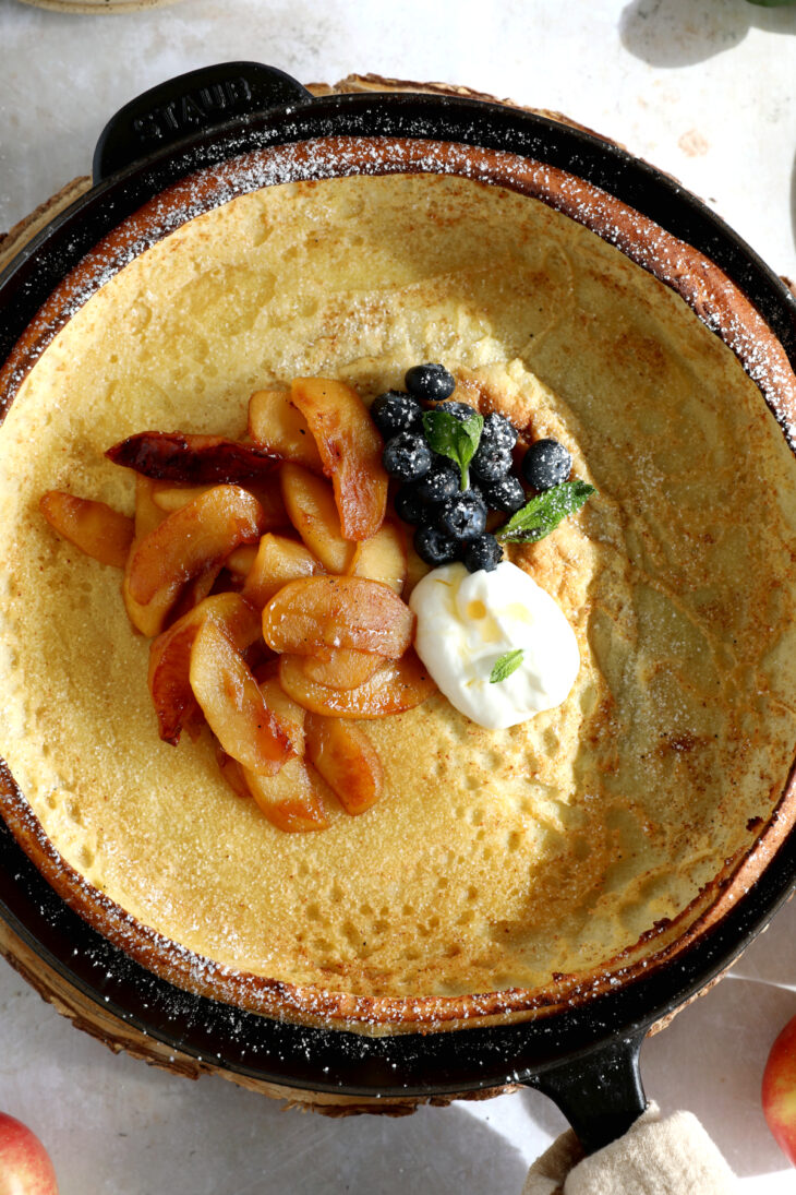 Apple Dutch Baby Pancake - Baked in a large, hot skillet, this giant pancake puffs up like a popover and is topped with caramelized apples.